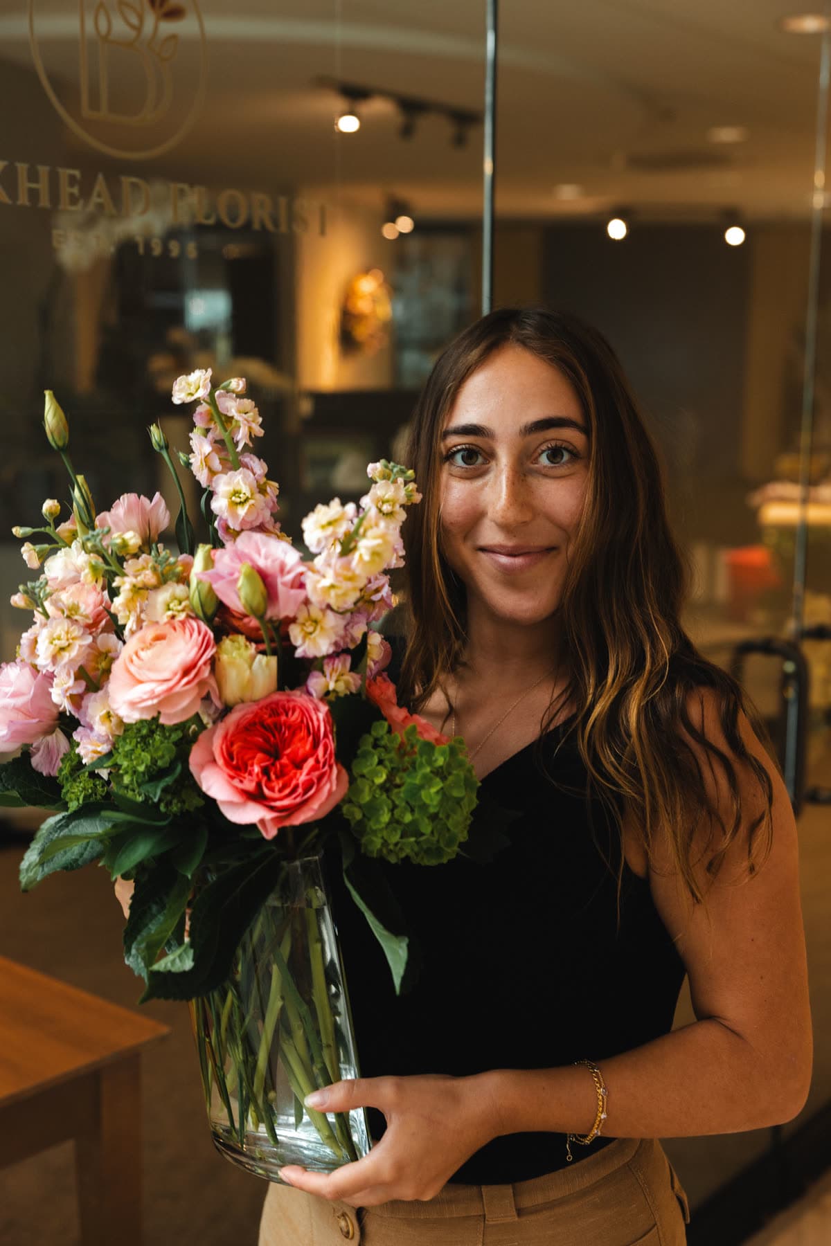 A florist with a finished arrangement