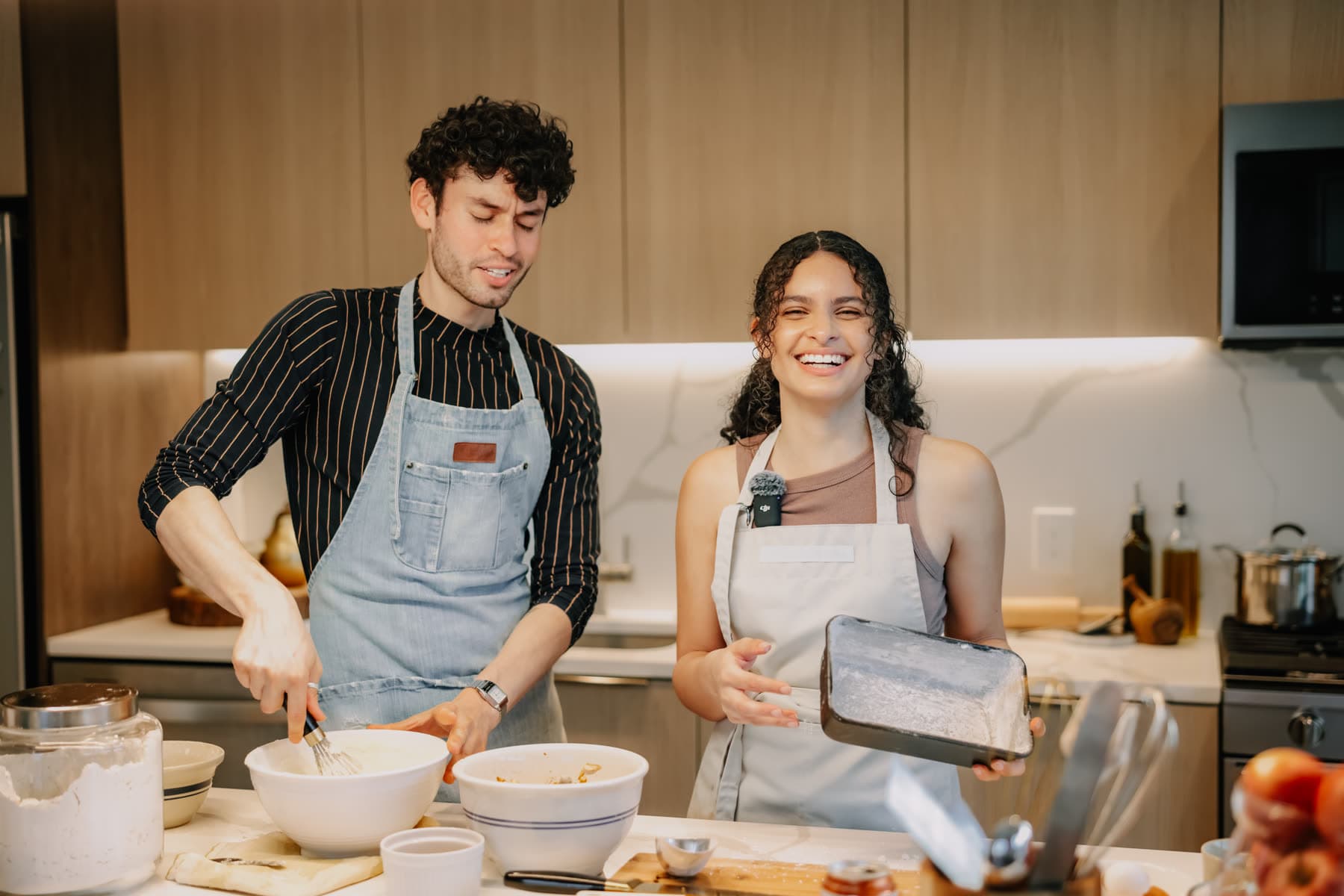 Two people working side by side in a shared kitchen