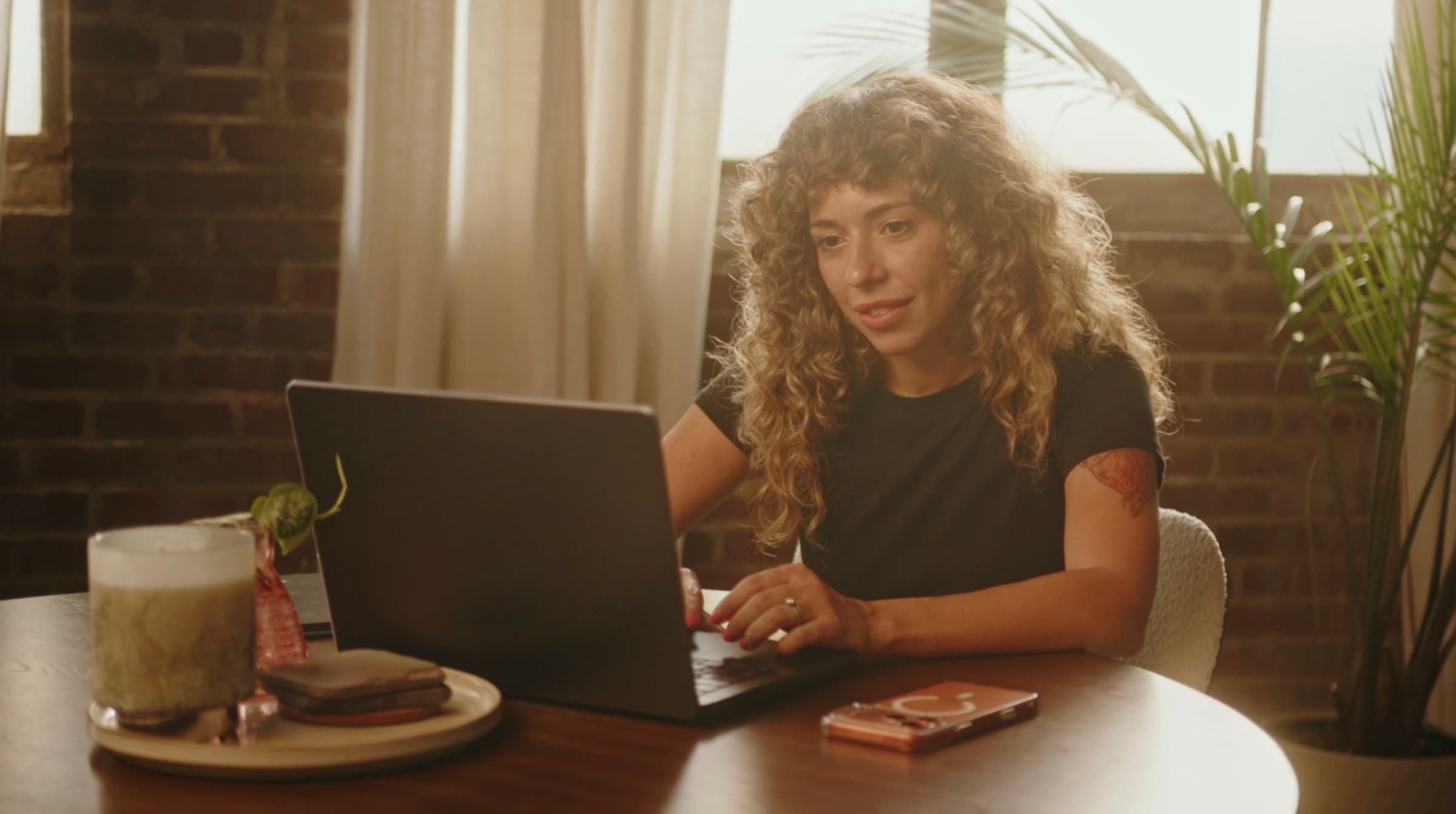 A self-employed professional working at a laptop at home